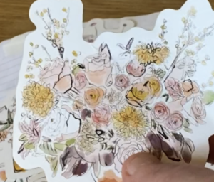 hand holding ephemera and affordable embellishment organization notebooks